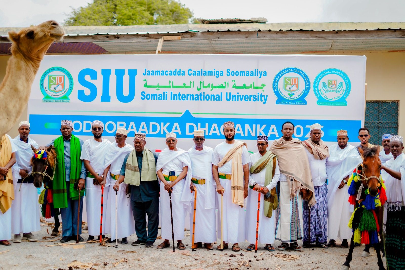SIU Cultural Week 2025 — students and dignitaries in traditional Somali dress, with camel and decorated horses, in front of the official SIU Cultural Week banner
